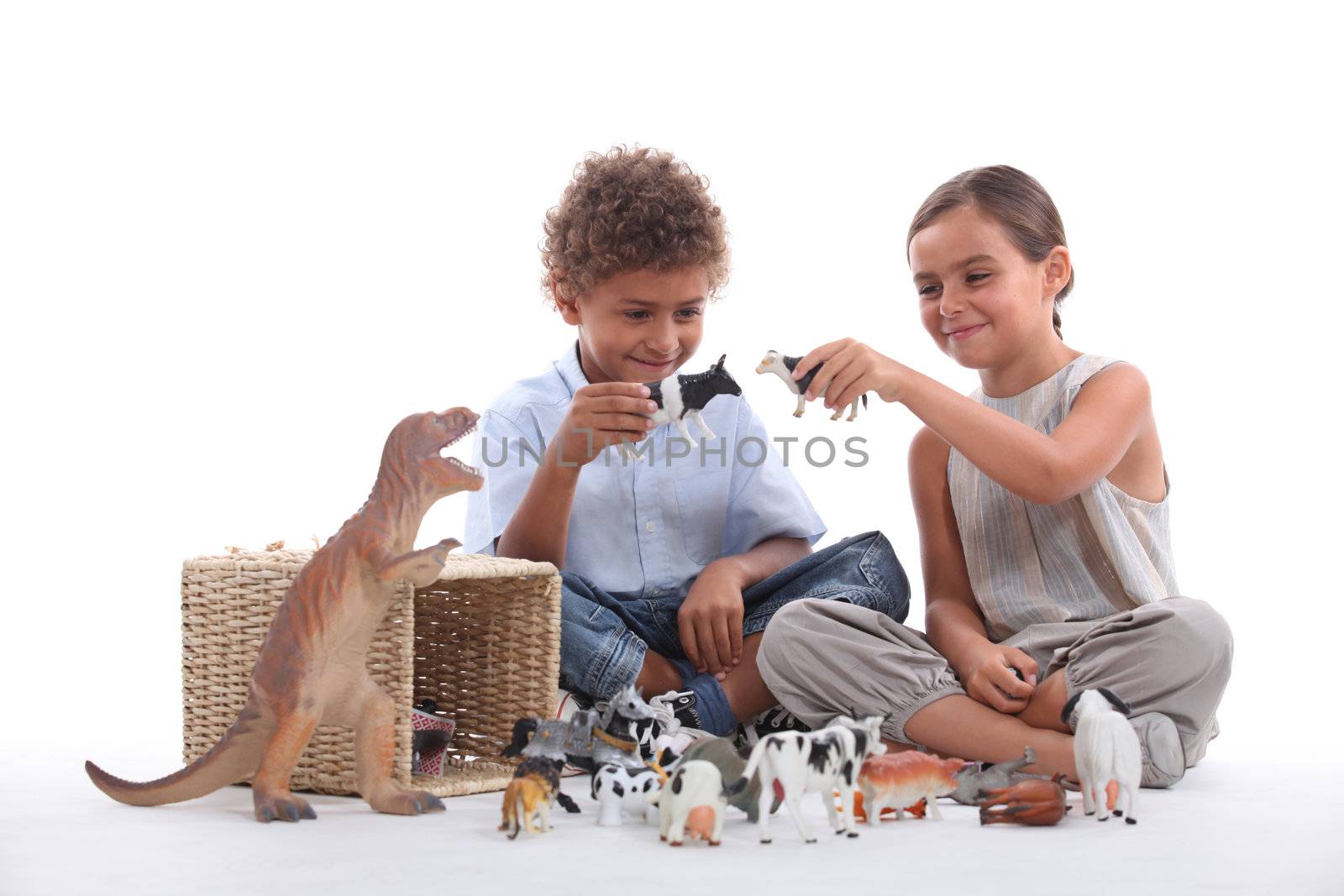 Child playing with toy animals by phovoir