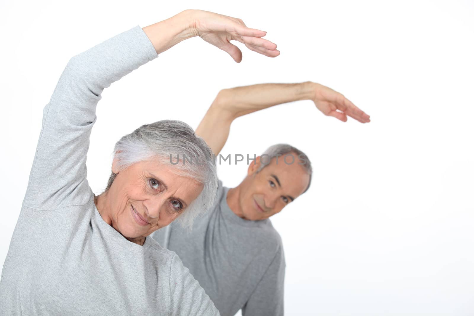 Elderly couple warming up by phovoir