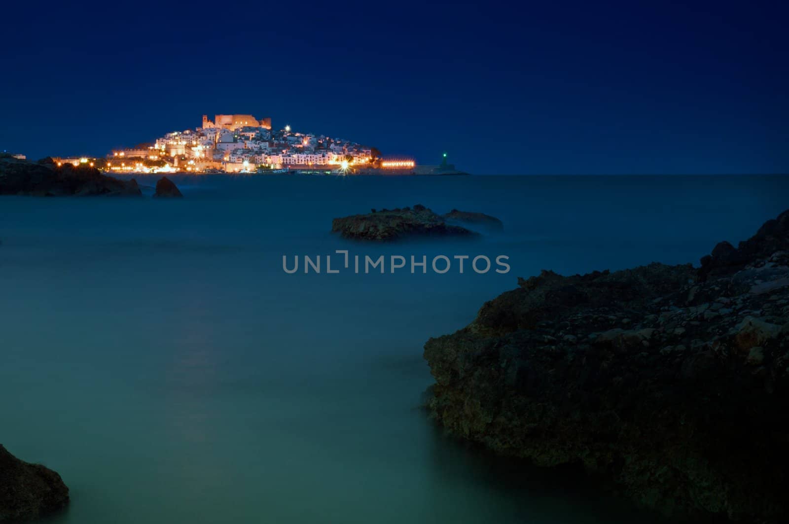 Night image of the Spanish city of Peniscola, on the shores of the Mediterranean, surrounded by the calm sea