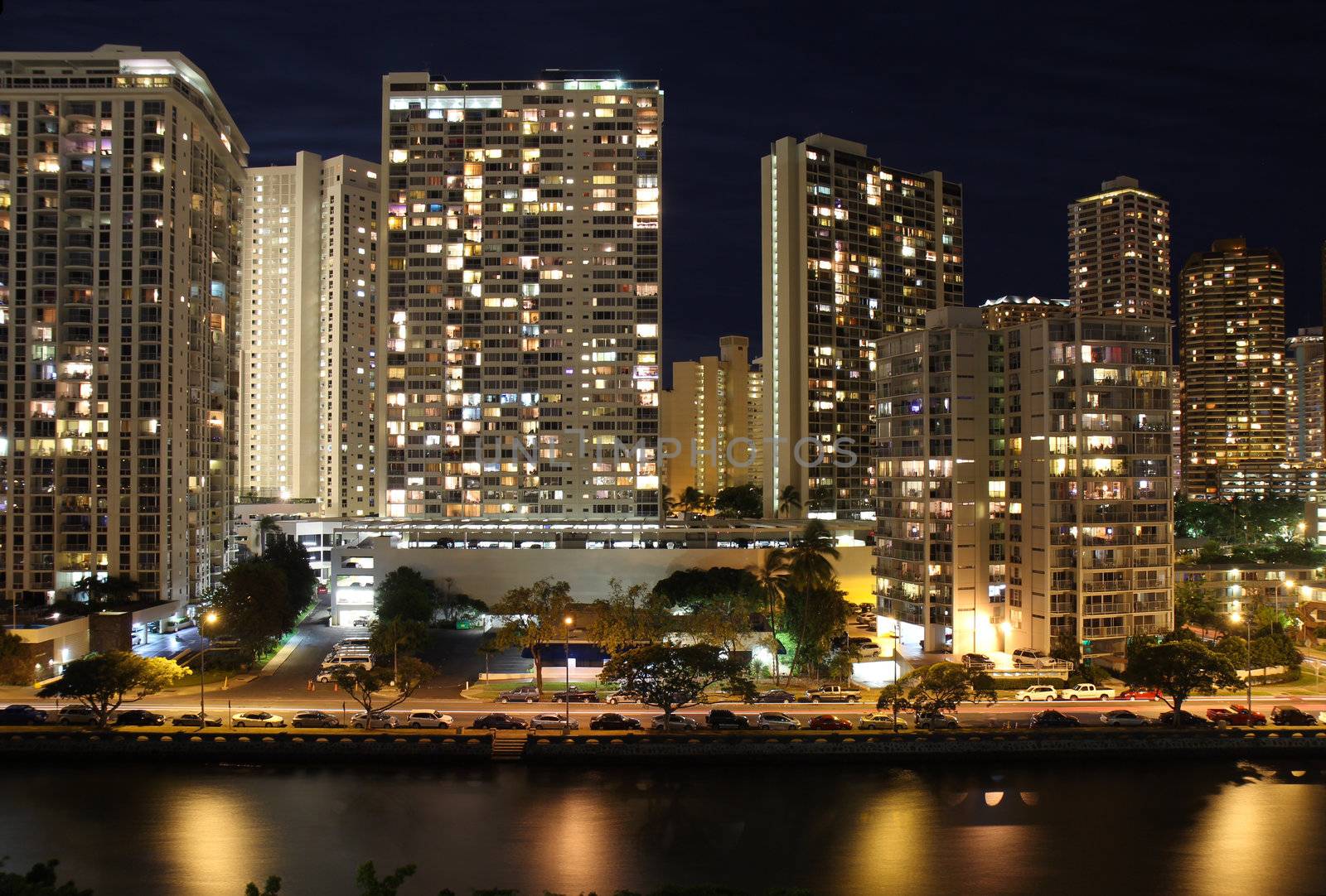 Skyscrapers and partial skyline of Honolulu, Hawaii, at night by sgoodwin4813