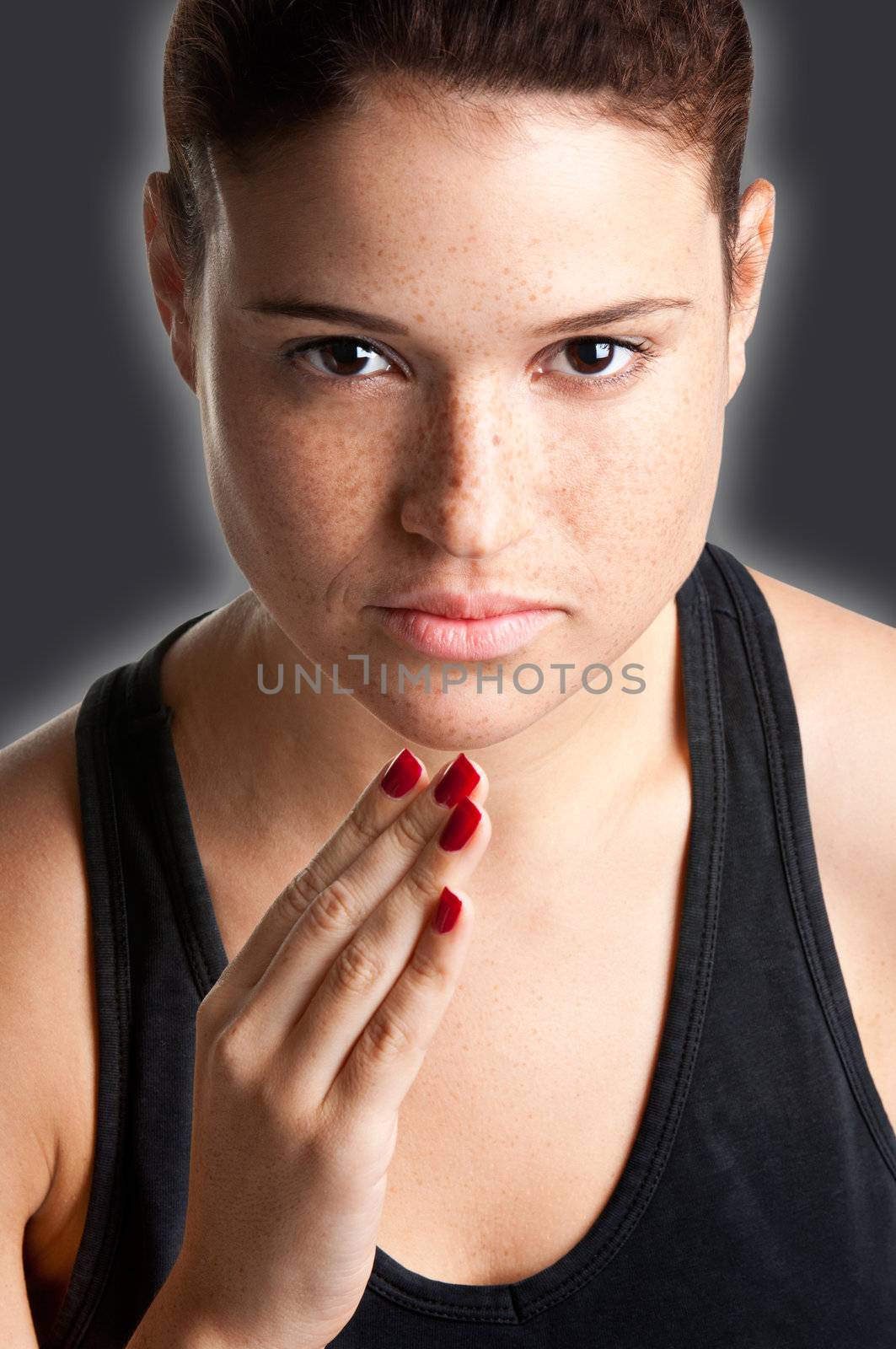 Close up portrait of a young fit woman jogging in a dark background