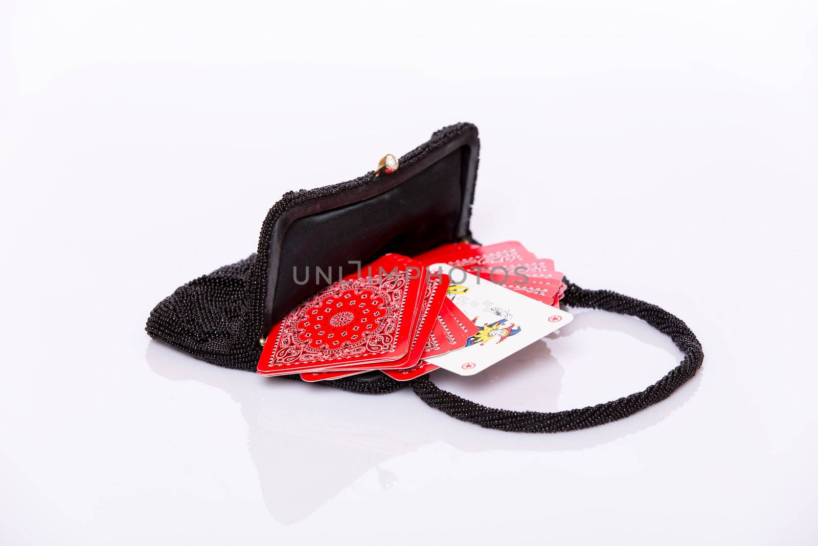 Small black lady handbag and red play cards