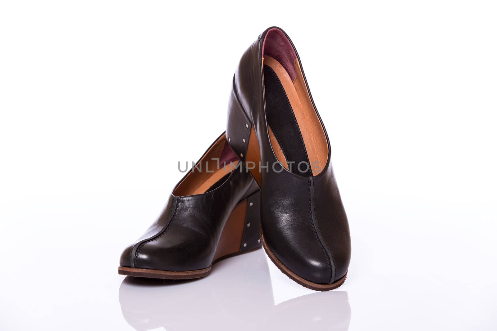 Pair of woman leather original shoes with wedge sole