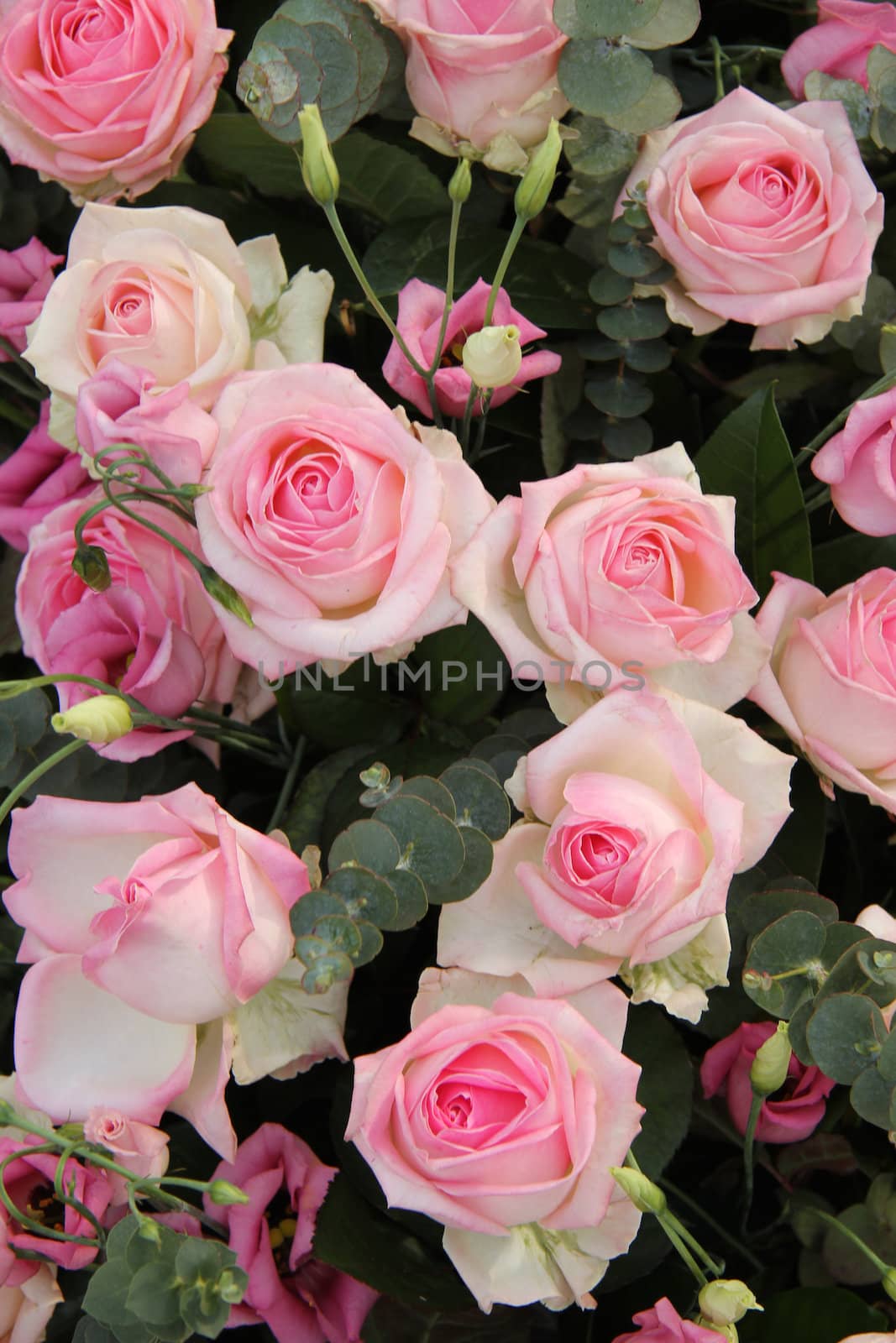 Lisianthus and roses in a pink wedding centerpiece