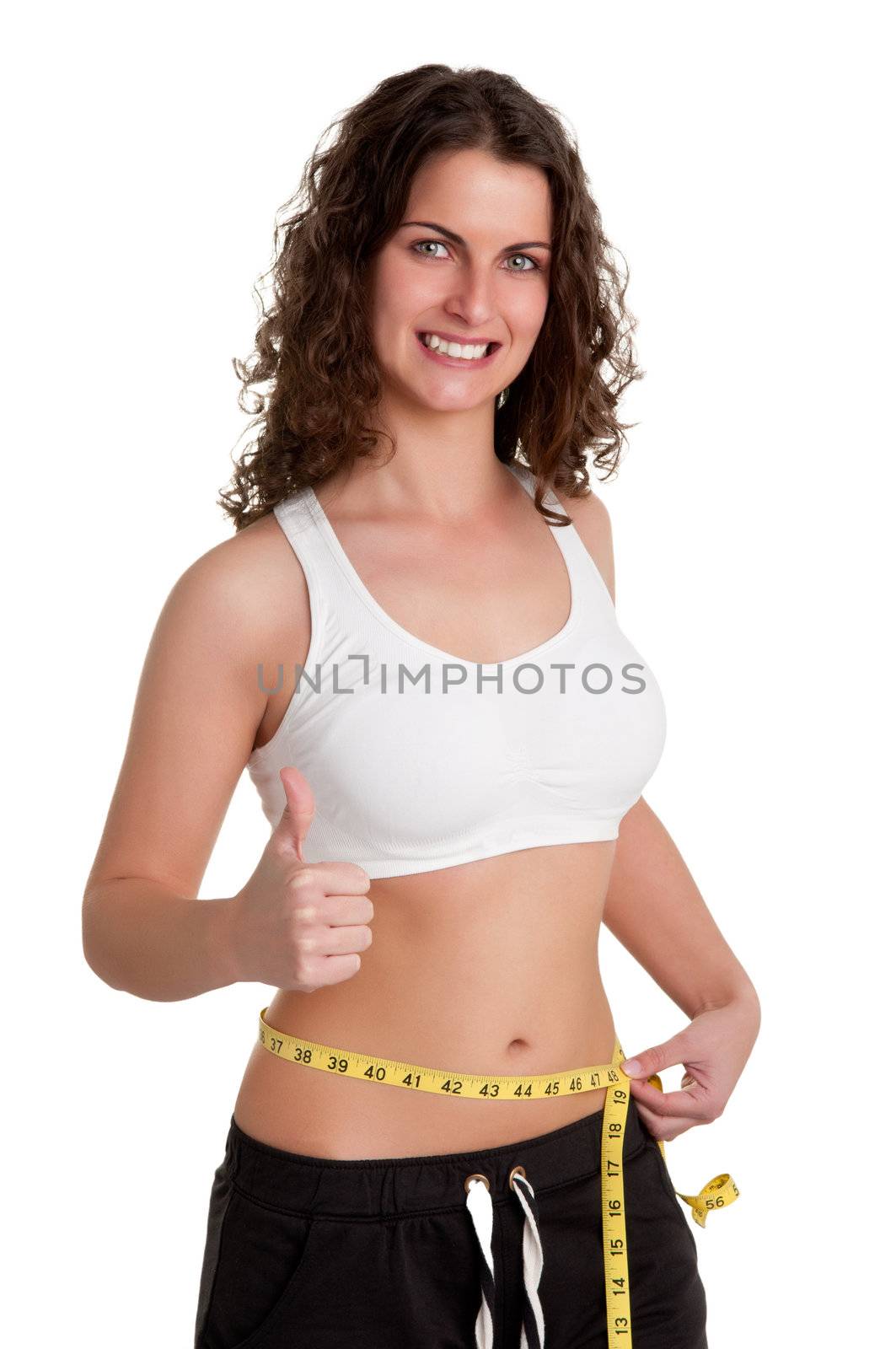 Woman measuring her waist with a yellow measuring tape, isolated in white