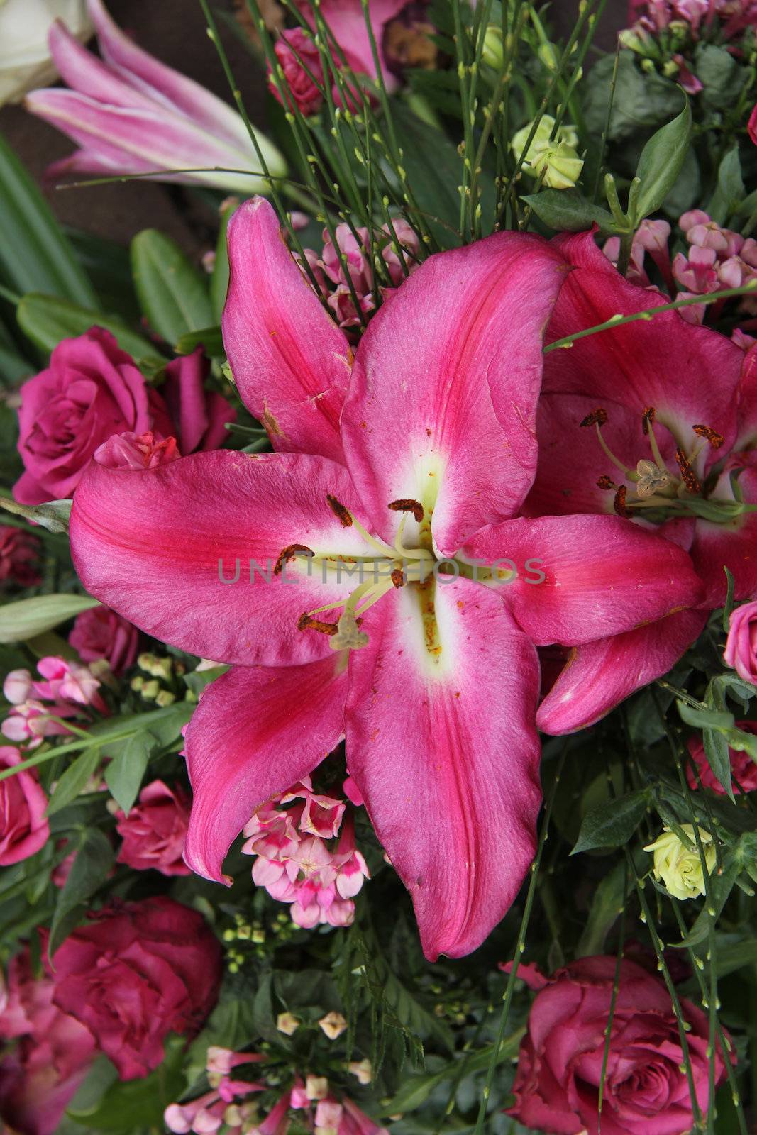 A big pink tiger lily in a floral arrangement