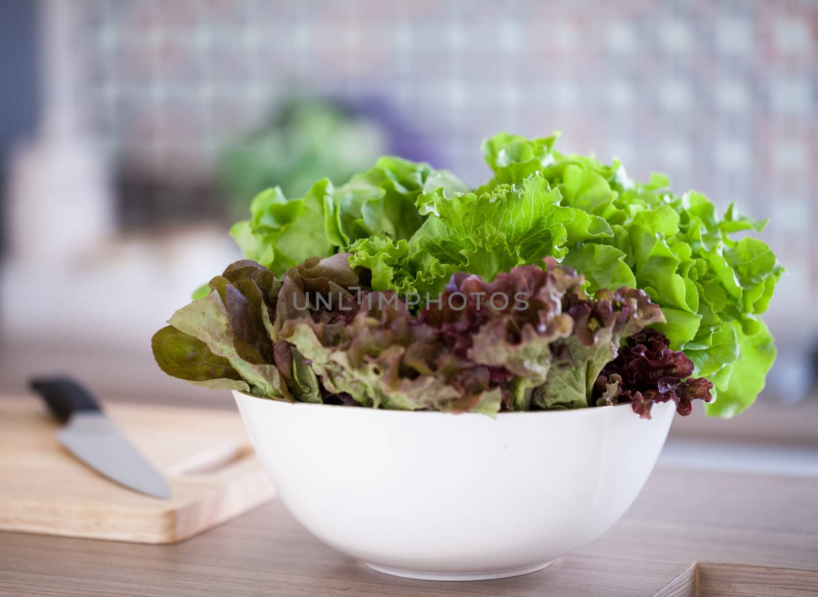 Preparing of Green Salad in domestic kitchen