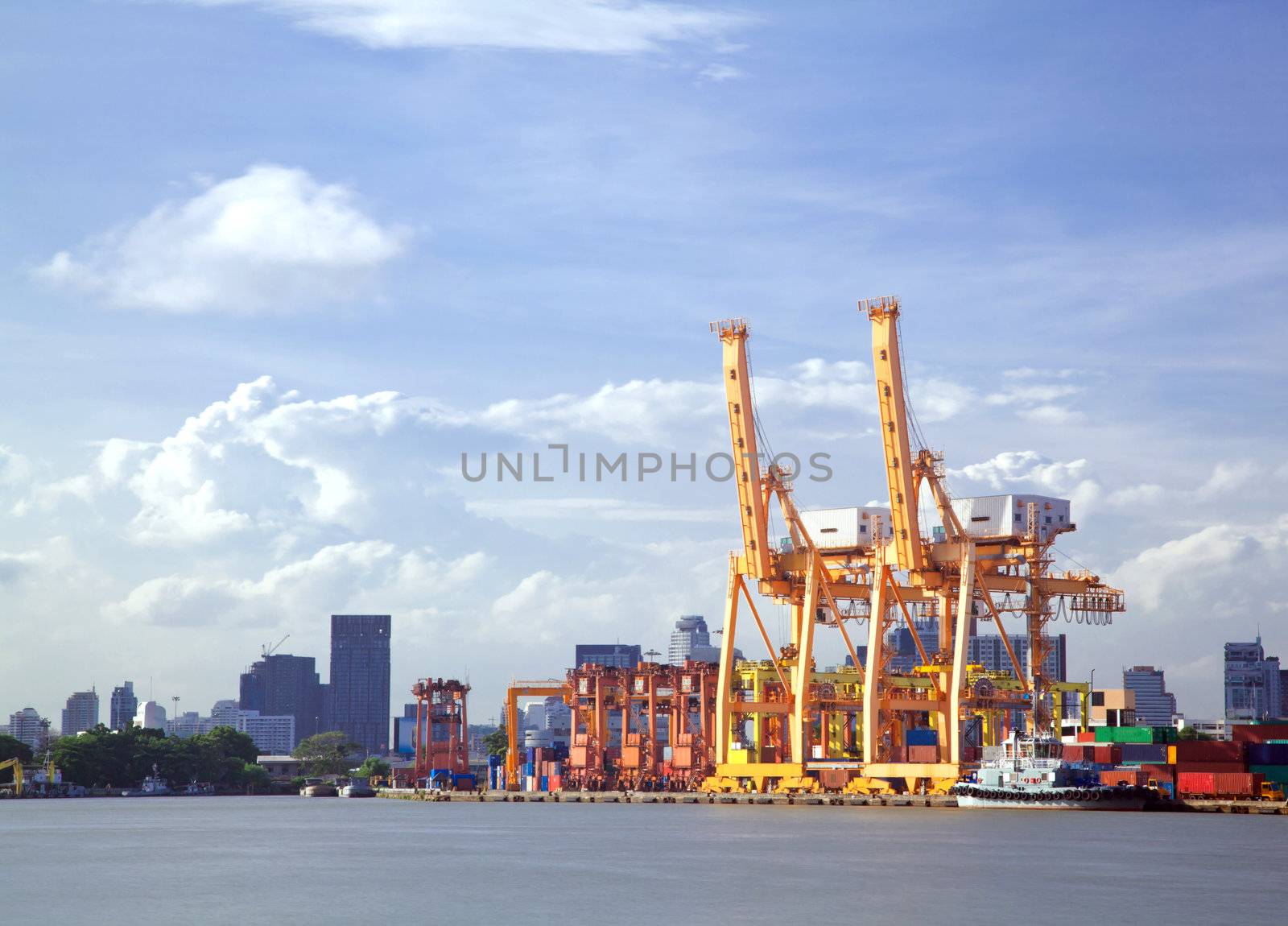 Container stacks and crane bridge in shipyard for cargo and Logistic background
