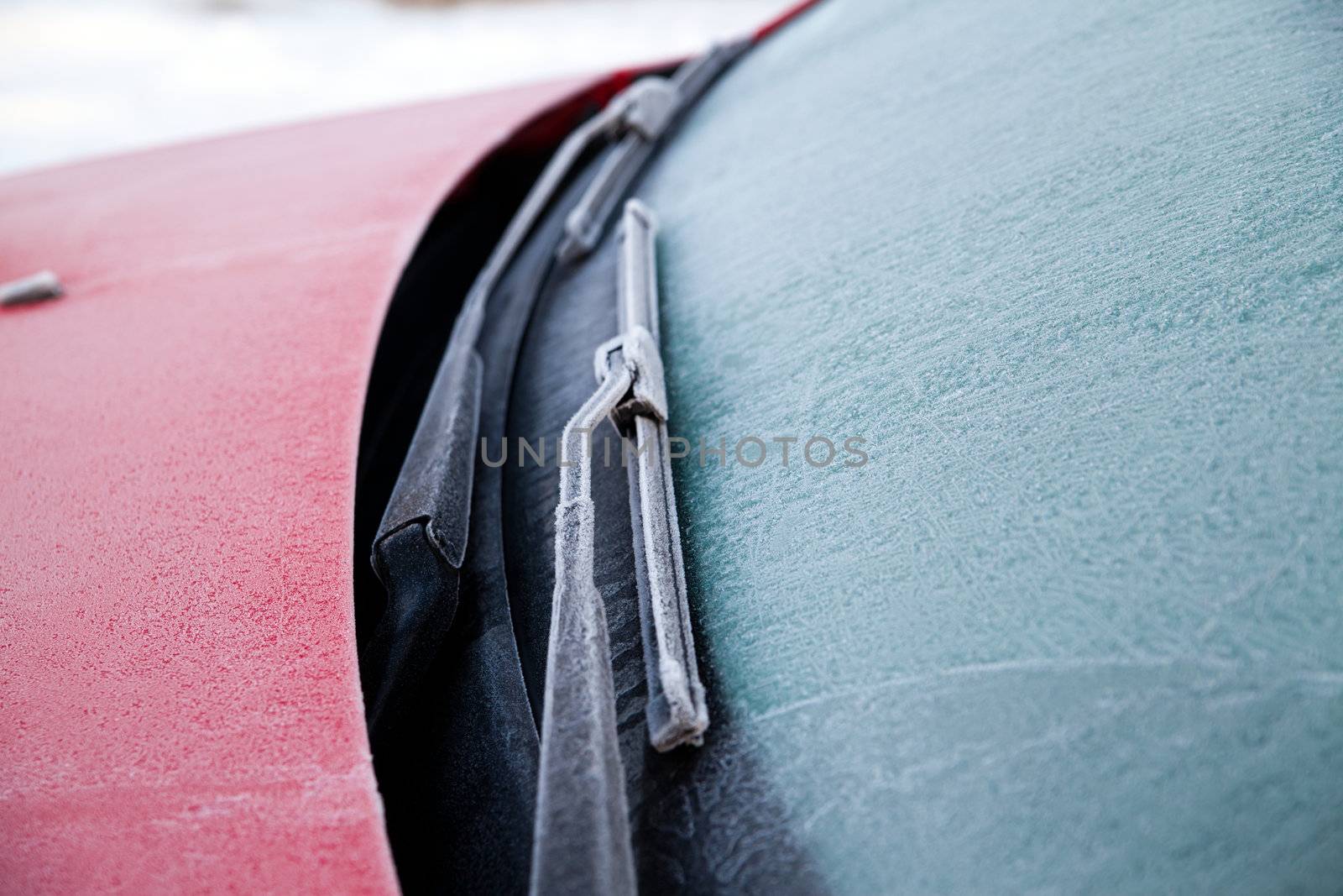 Frozen front windshield of car during winter morning
