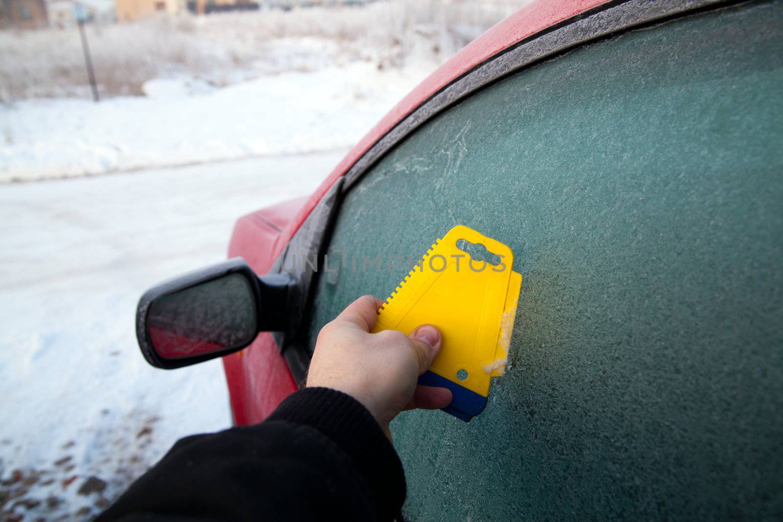 Frozen car window during winter morning
