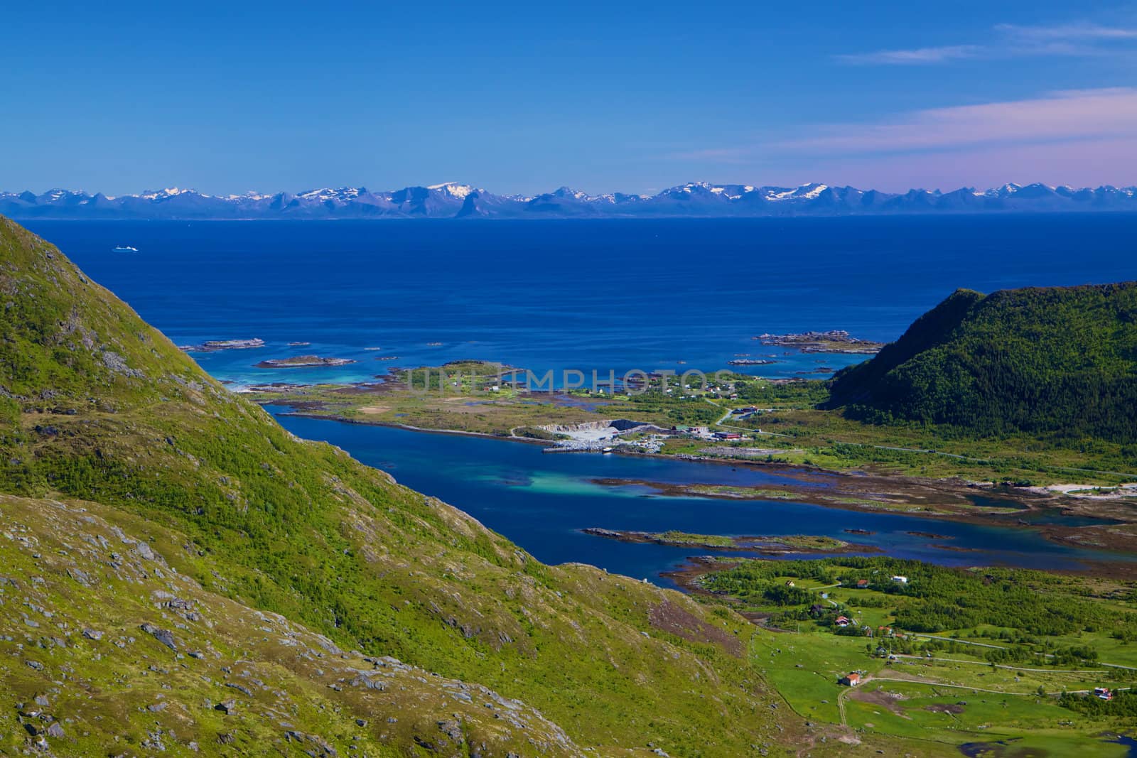 Scenic panorama of green Lofoten islands in Norway during summer with norwegian mainland coast on the horizon