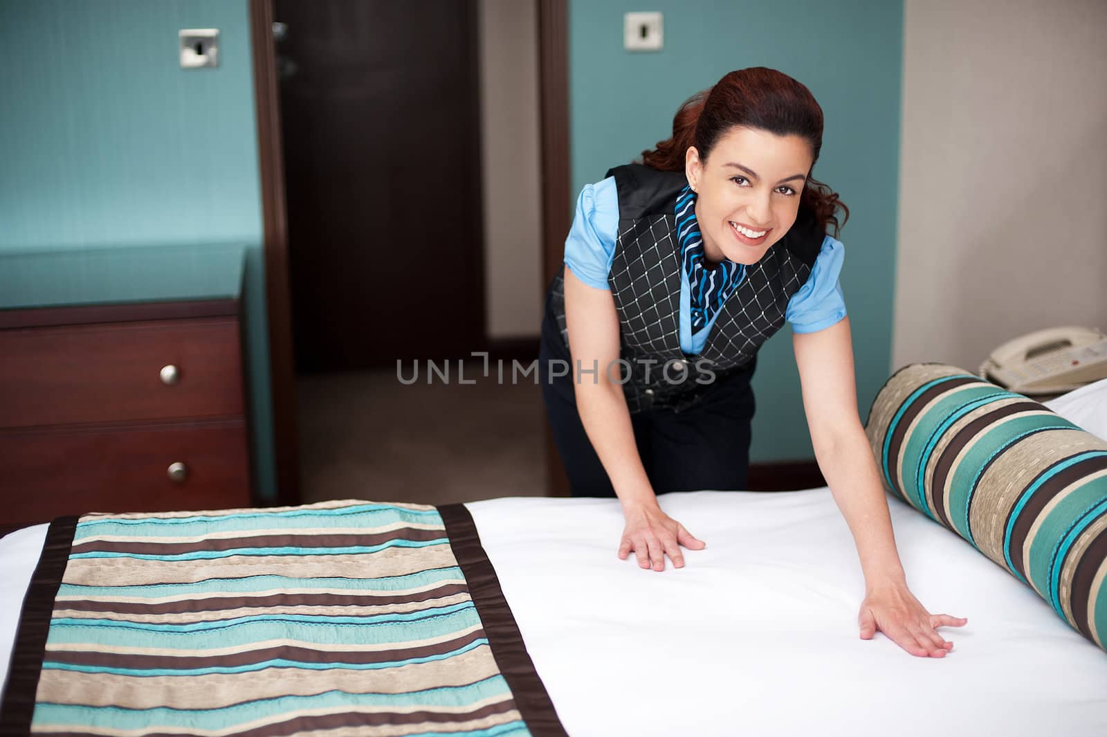 Casual shot of cheerfully working housekeeping employee