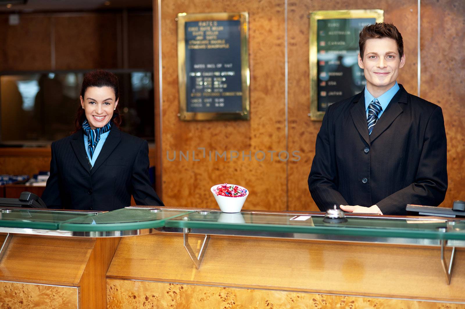 Front desk colleagues posing for a picture. Smiling cheerfully while looking at camera