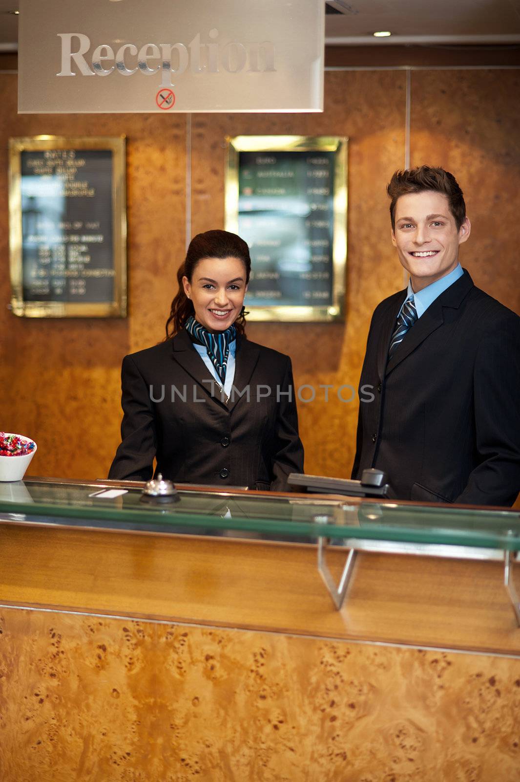 Trendy adorable couple at front office desk for customer assistance
