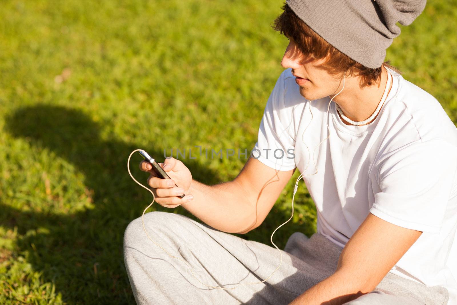 young handsome man consulting phone outdoors