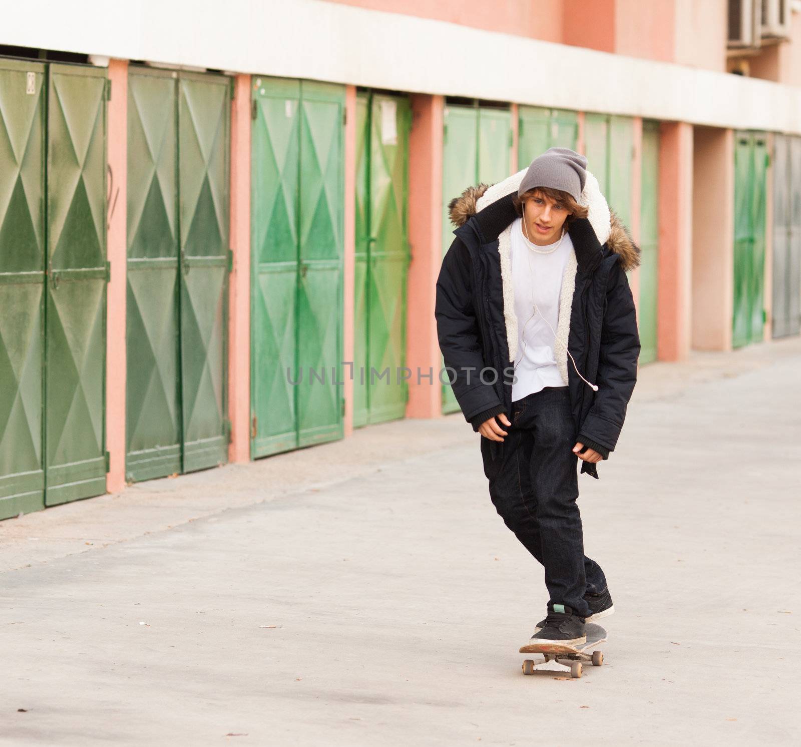 young skater rolling down the street by Lcrespi