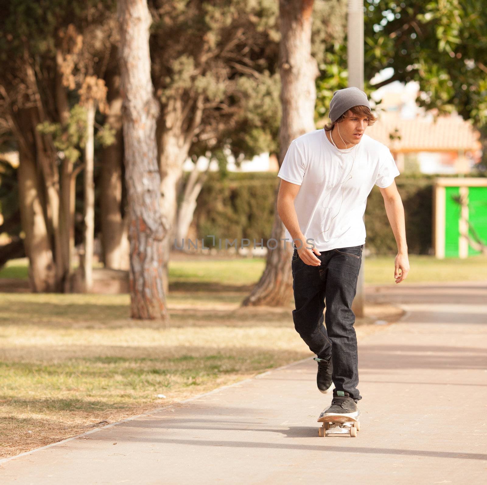 young skater rolling down the street by Lcrespi