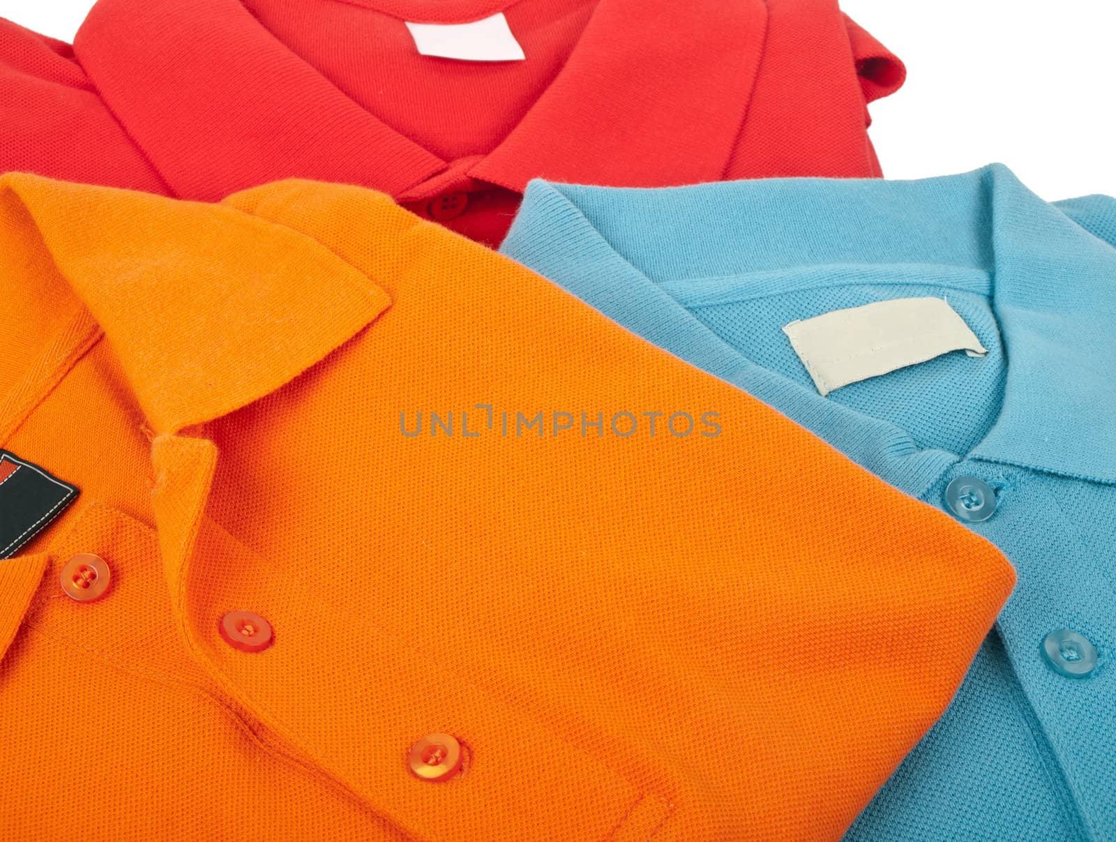 pile of man polo shirts on white background