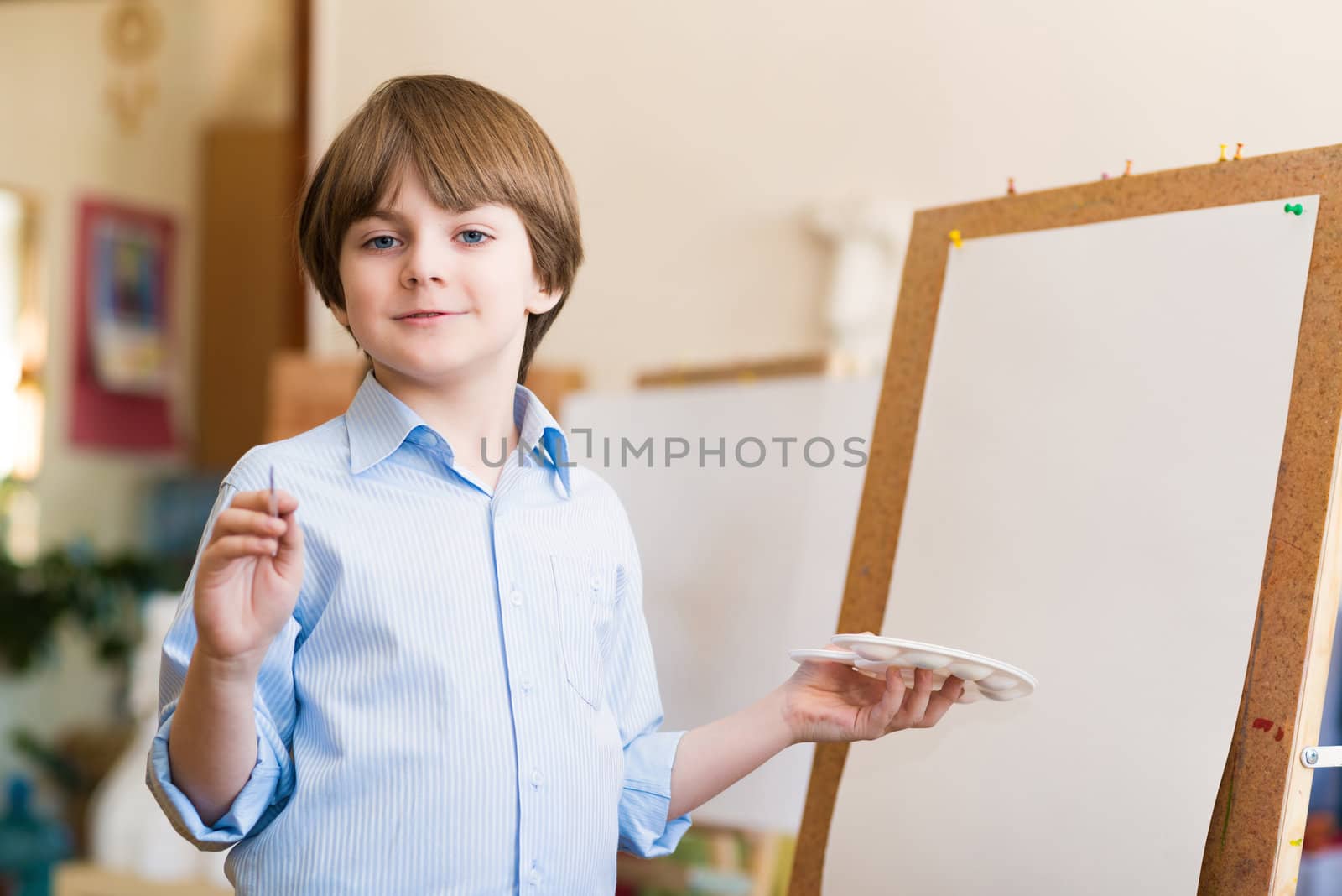 portrait of a boy standing next to his easel, a drawing lesson