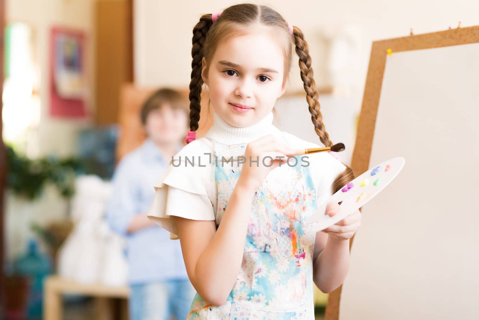 portrait of a girl standing next to his easel, a drawing lesson