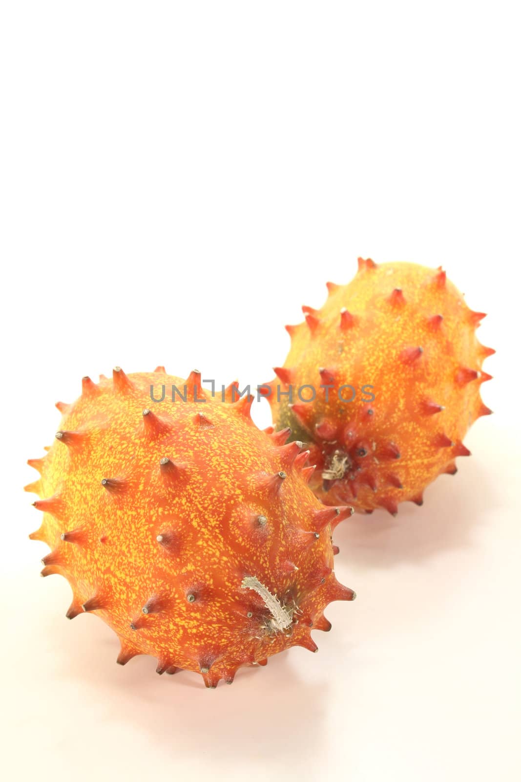 two fresh horned melon on a light background