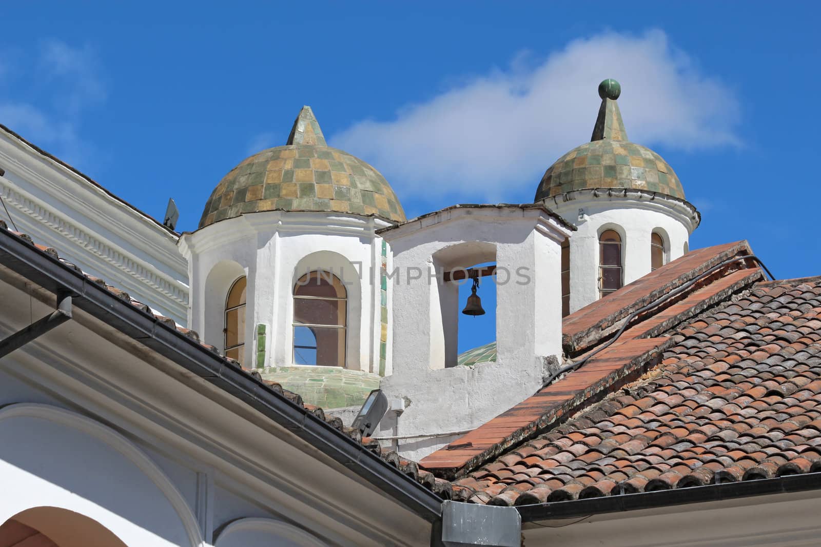 Close-up of domes and a bell from the courtyard of the church and monastery of San Francisco in Quito, Ecuador