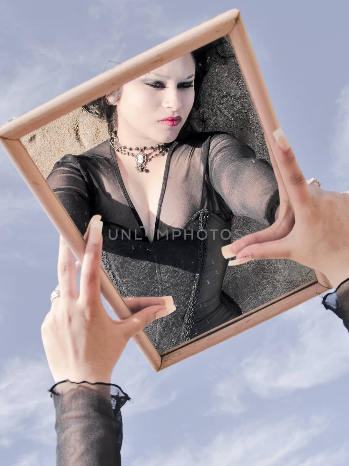 Woman reflected on a mirror which is holded up