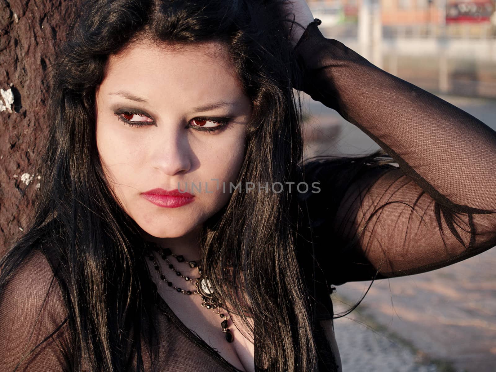 Pretty gothic woman relaxing at sunset, portrait