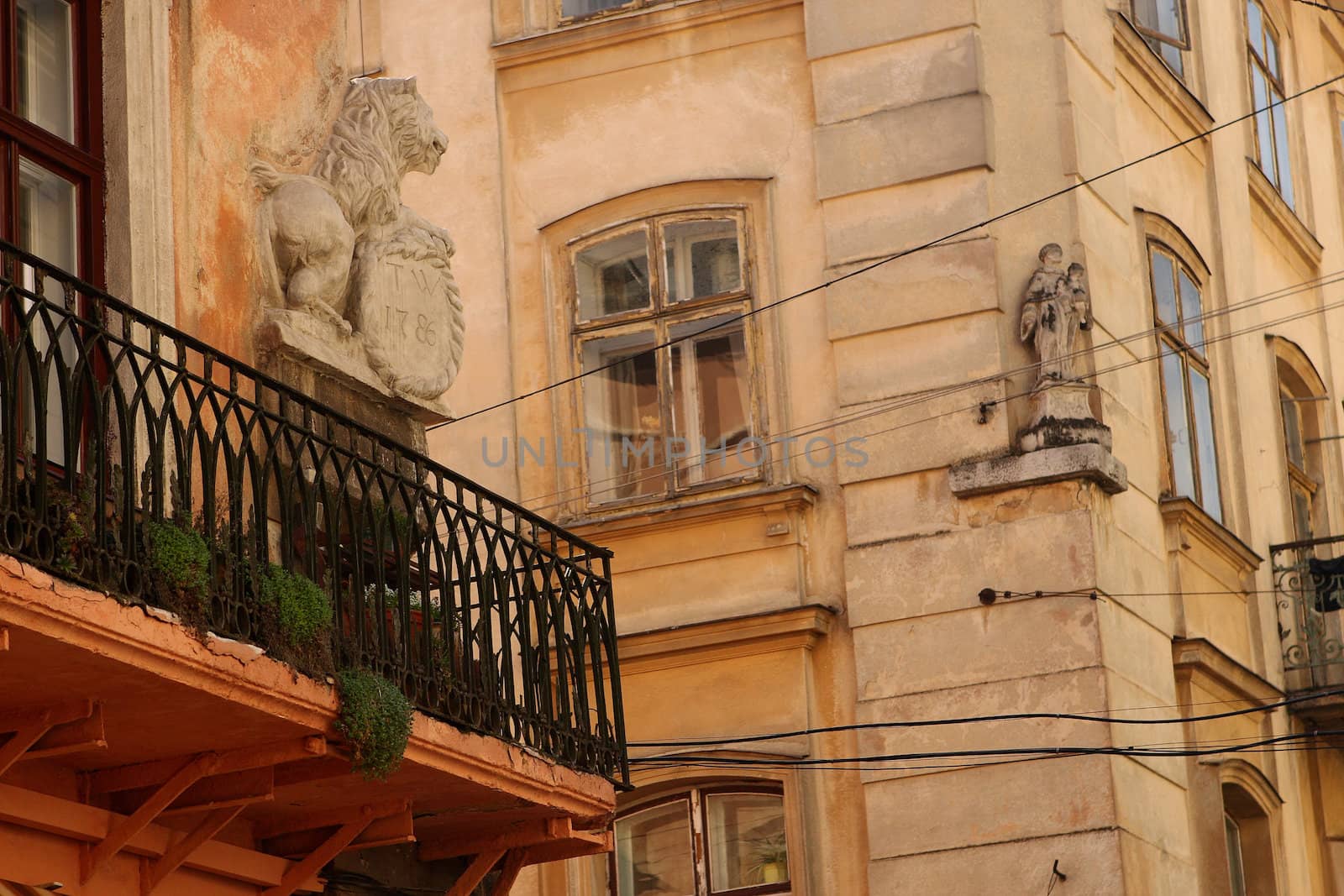 A house with a balcony and a lion in the Galician street in Lvov  by cococinema