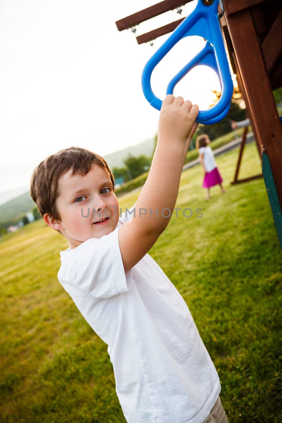 Boy at the rings in a playground