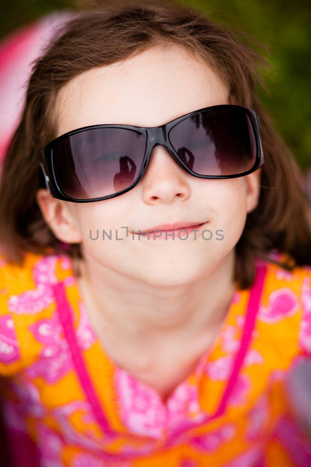 Little girl with sunglasses smiling