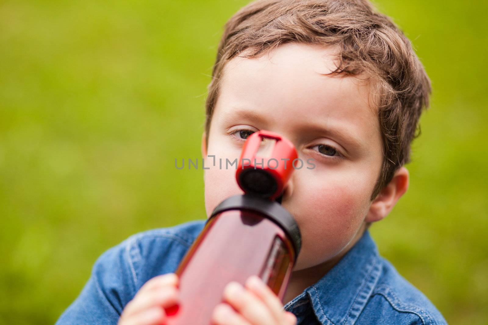 Boy drinking water on a summer day