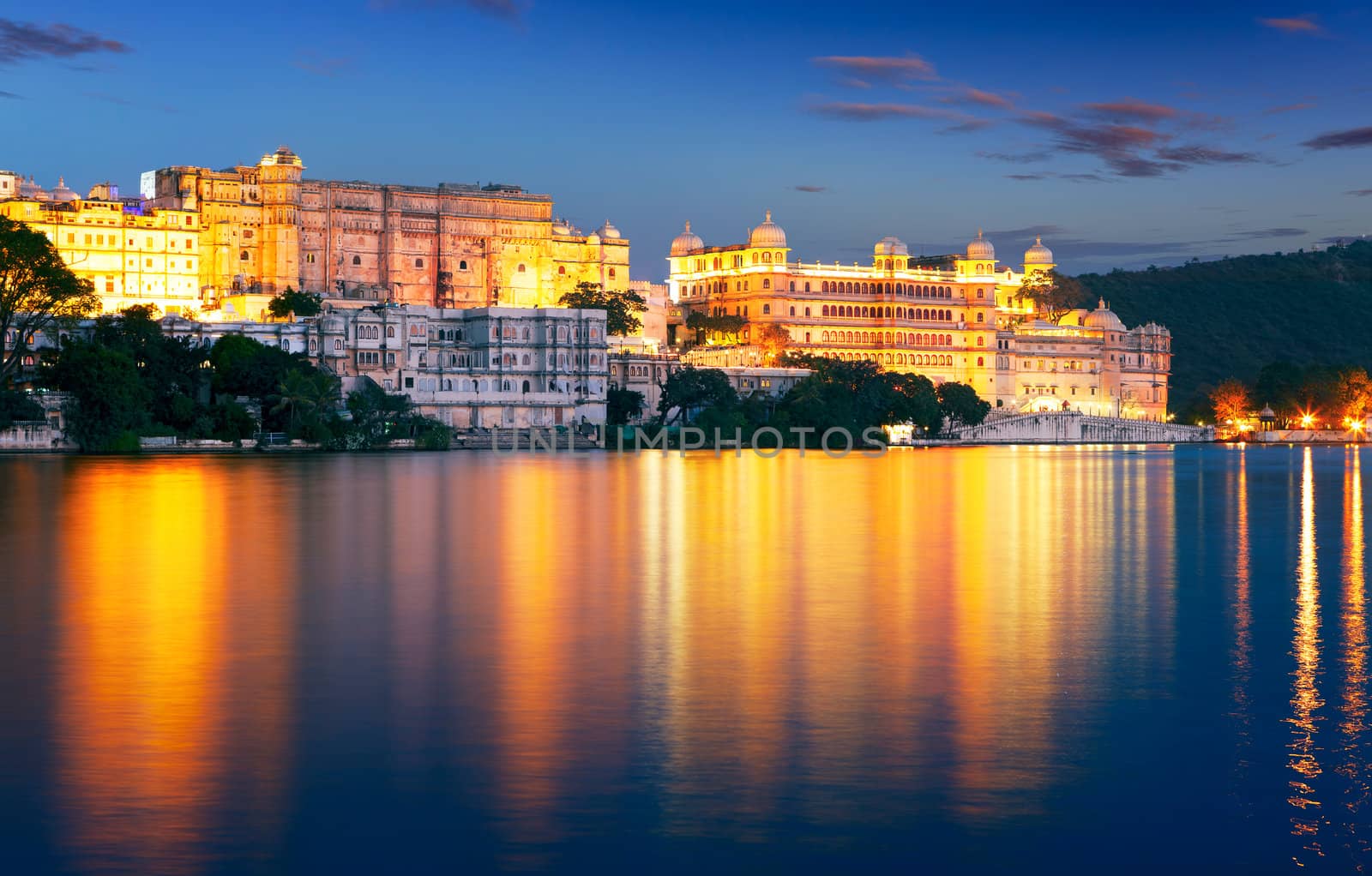 Pichola lake and City Palace at night. Udaipur, Rajasthan, India, Asia