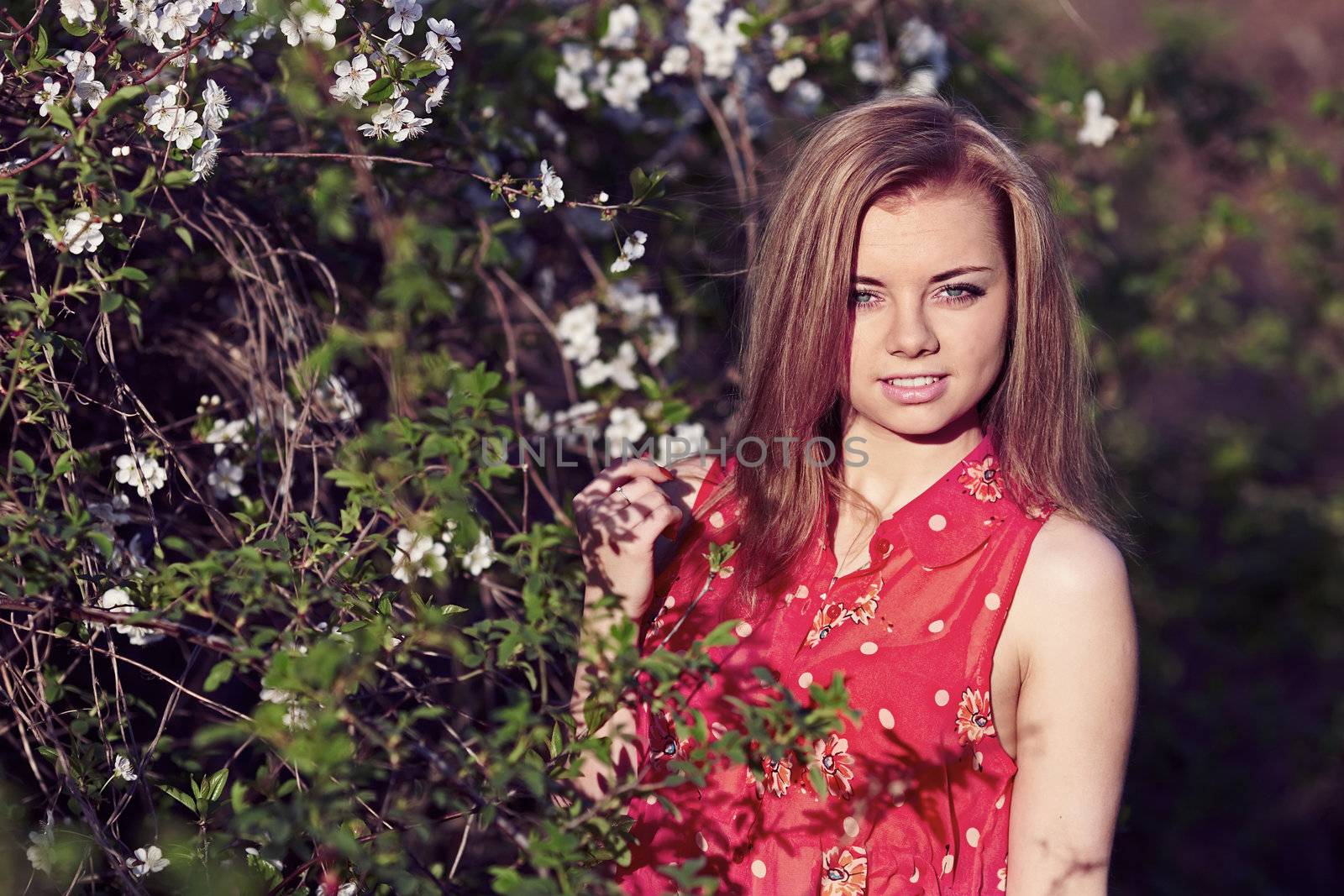 Beautiful girl in a red dress in the colors of cherry