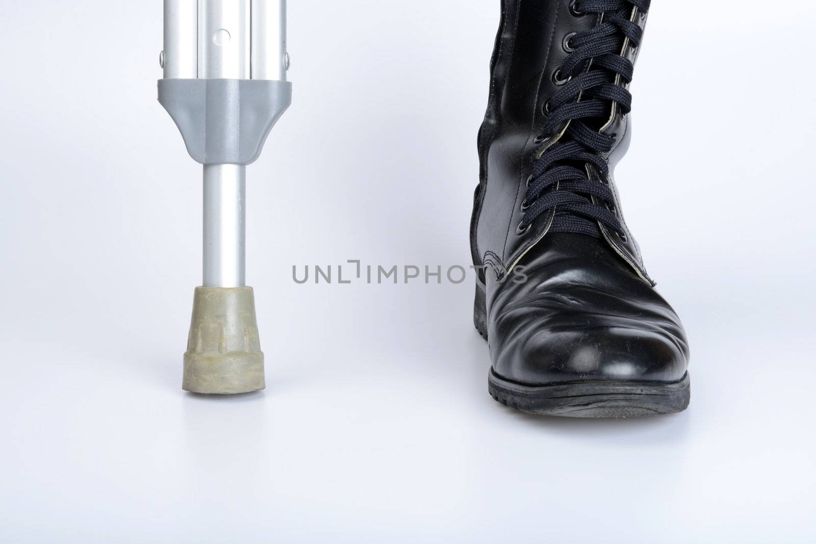 combat boot and crutch for war concept