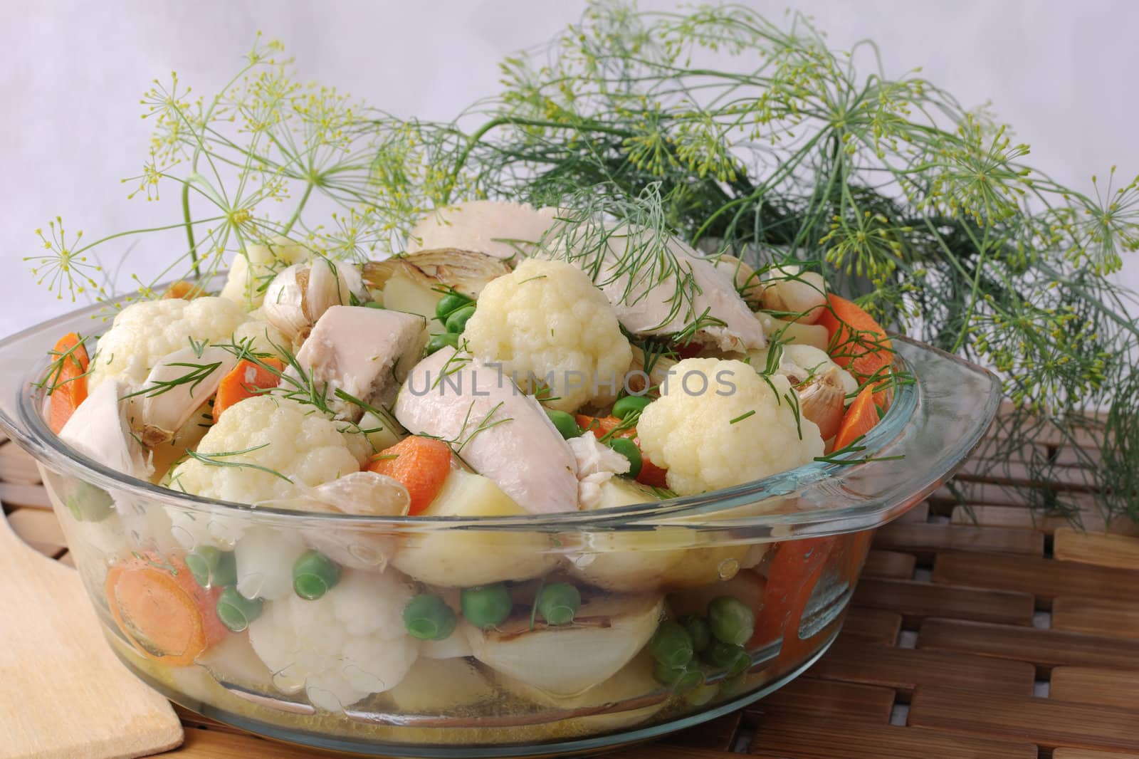 Roasted vegetables with slices of chicken and fennel in a pan