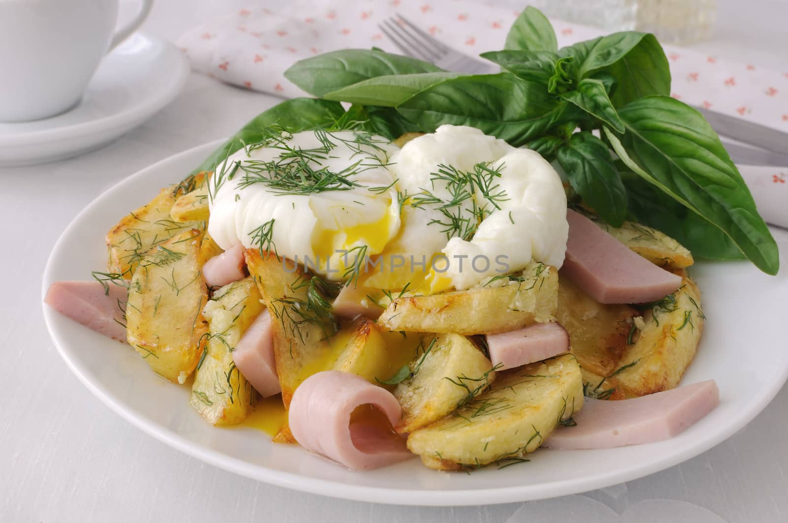 Delicious eggs benedict with fried potatoes and bacon for breakfast.