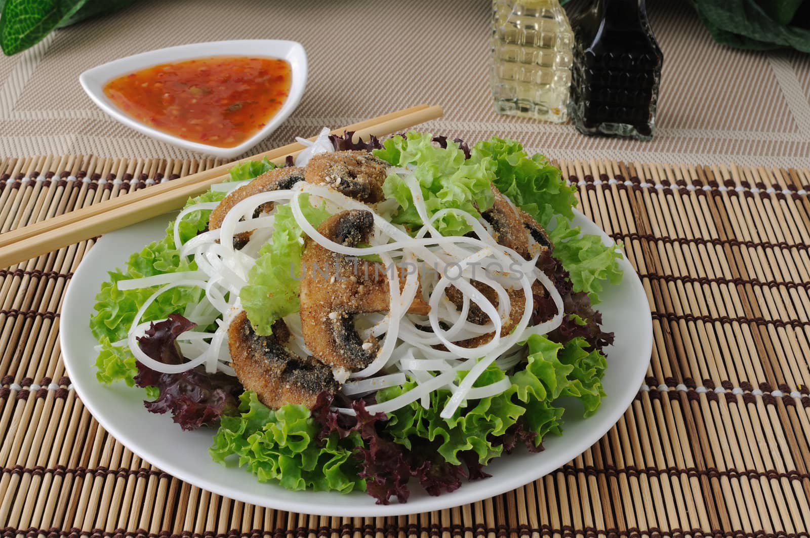 Salad of rice noodles in lettuce leaves with mushrooms in breadcrumbs