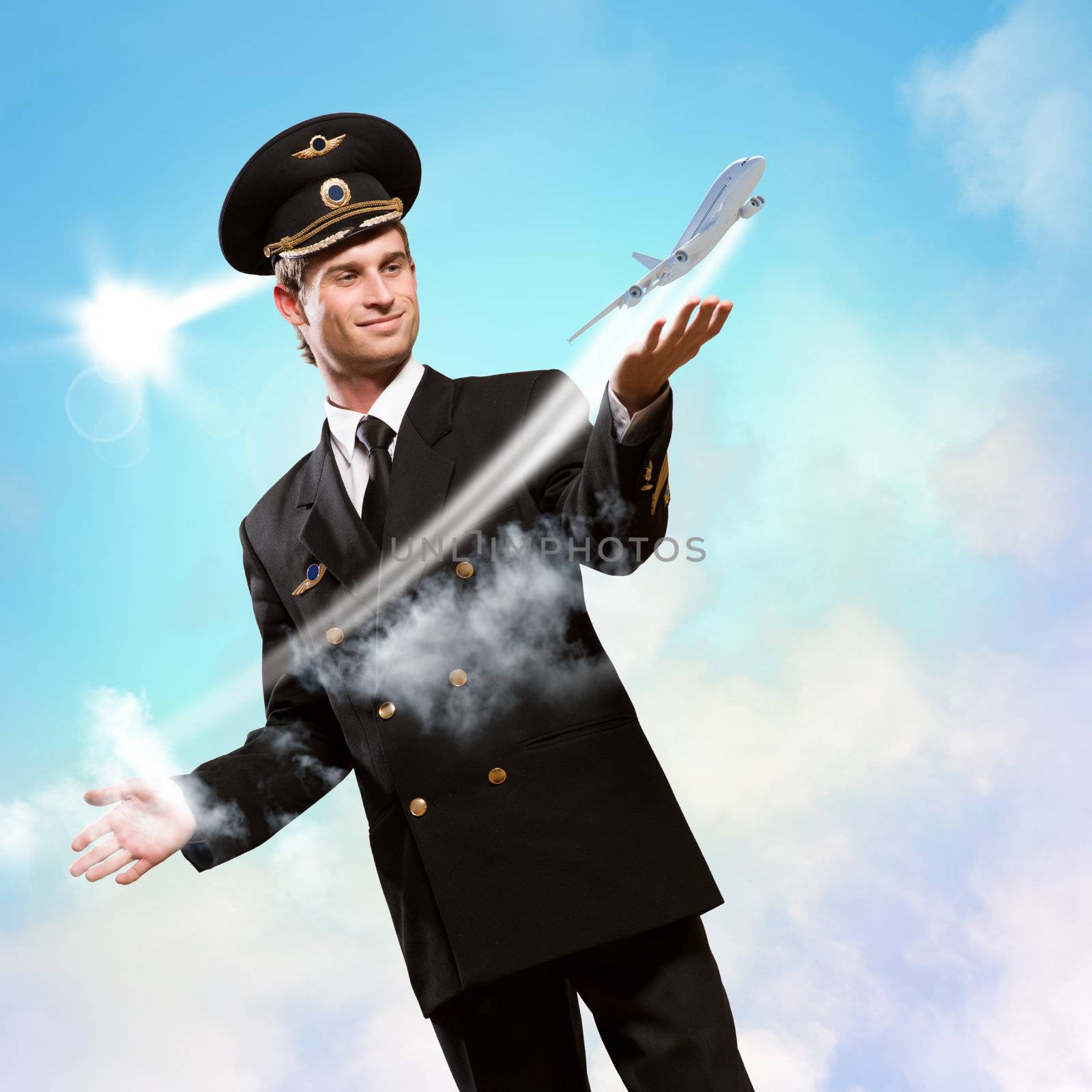 pilot in the form of extending a hand to a flying airplane on the background of clouds and sun