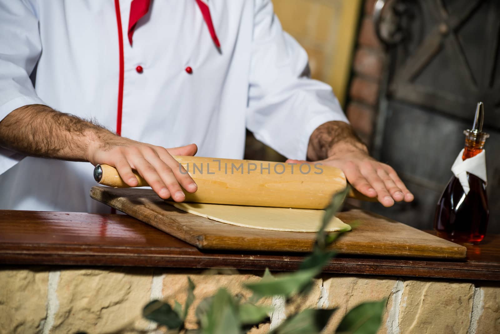 Cook rolls out the dough on a board, the traditional cooking