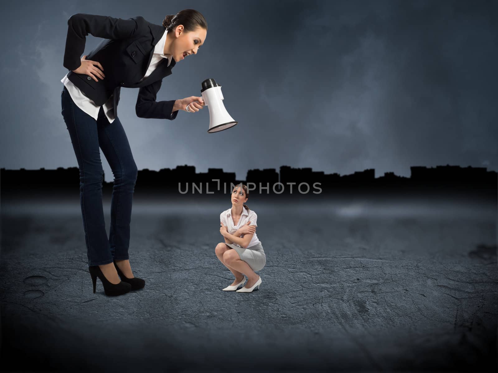 Business woman yelling at a small woman sitting on the ground, the concept of aggression