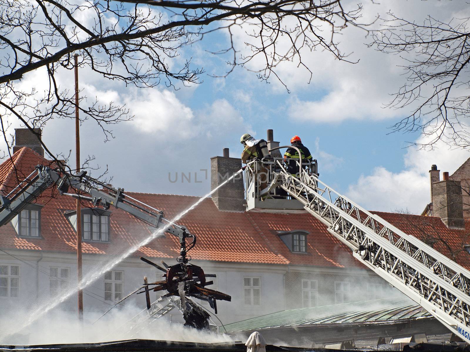 COPENHAGEN - APR 28: Firemen controls fire at The Museum of Danish Resistance 1940 -1945 on April 28, 2013 in Copenhagen, Denmark. It took 10 hours to put off the fire which started at 1:45 A.M.