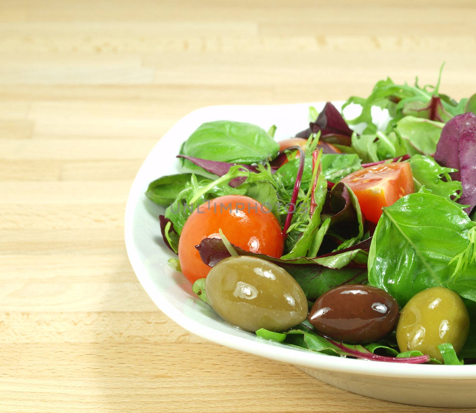 mixed baby green salad dressed with olive oil