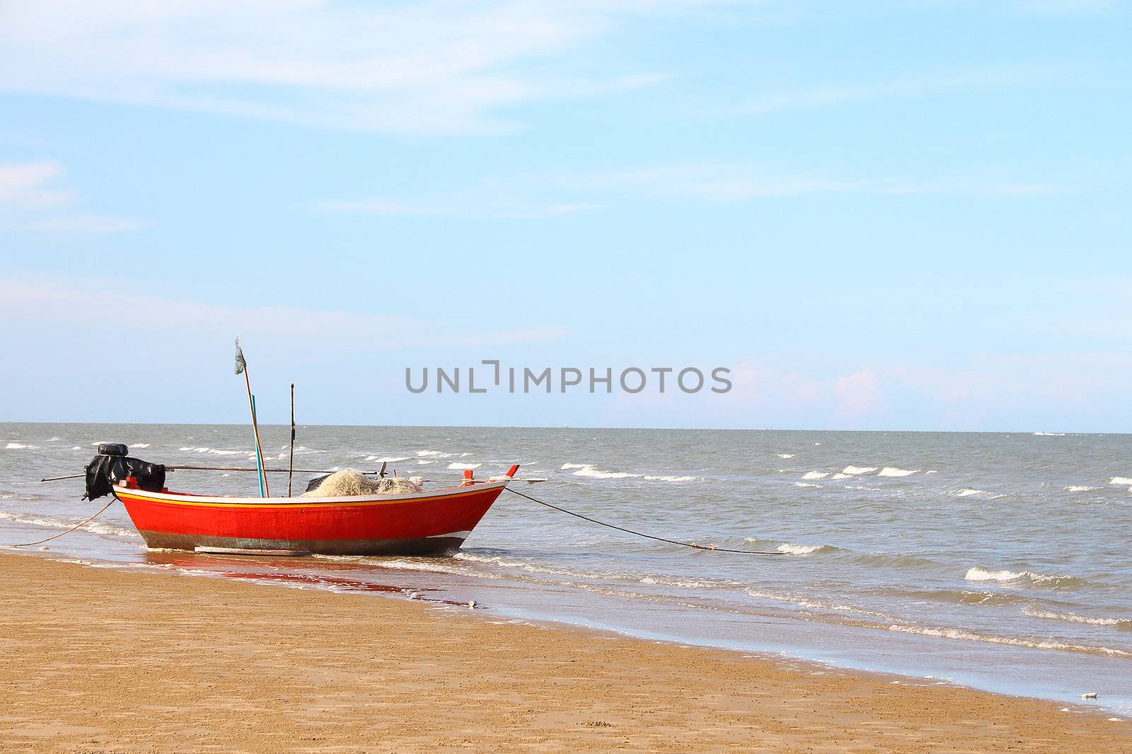 Fishing boat on the beach in front of the Pranburi sea 