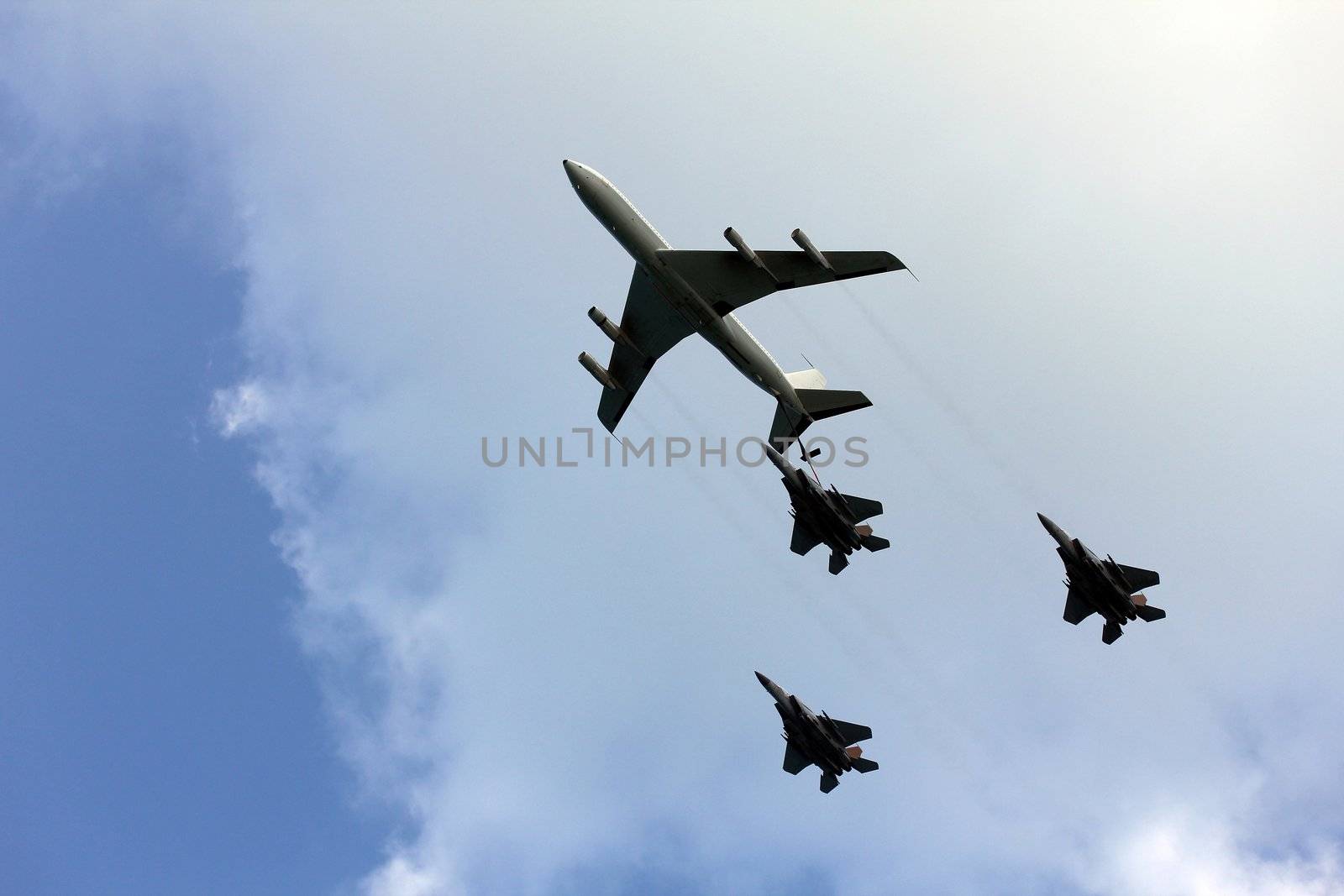 Israeli Air Force airplanes (four-engine turboprop powered refueling tanker  and three jet fighters) imitating aerial refueling at parade in honor of Independence Day