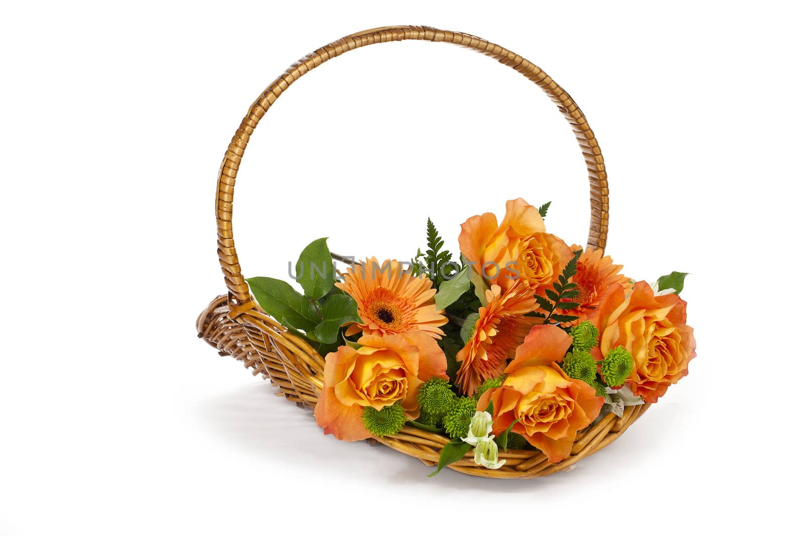 Close-up shot of a wicker basket with orange flowers on white surface.