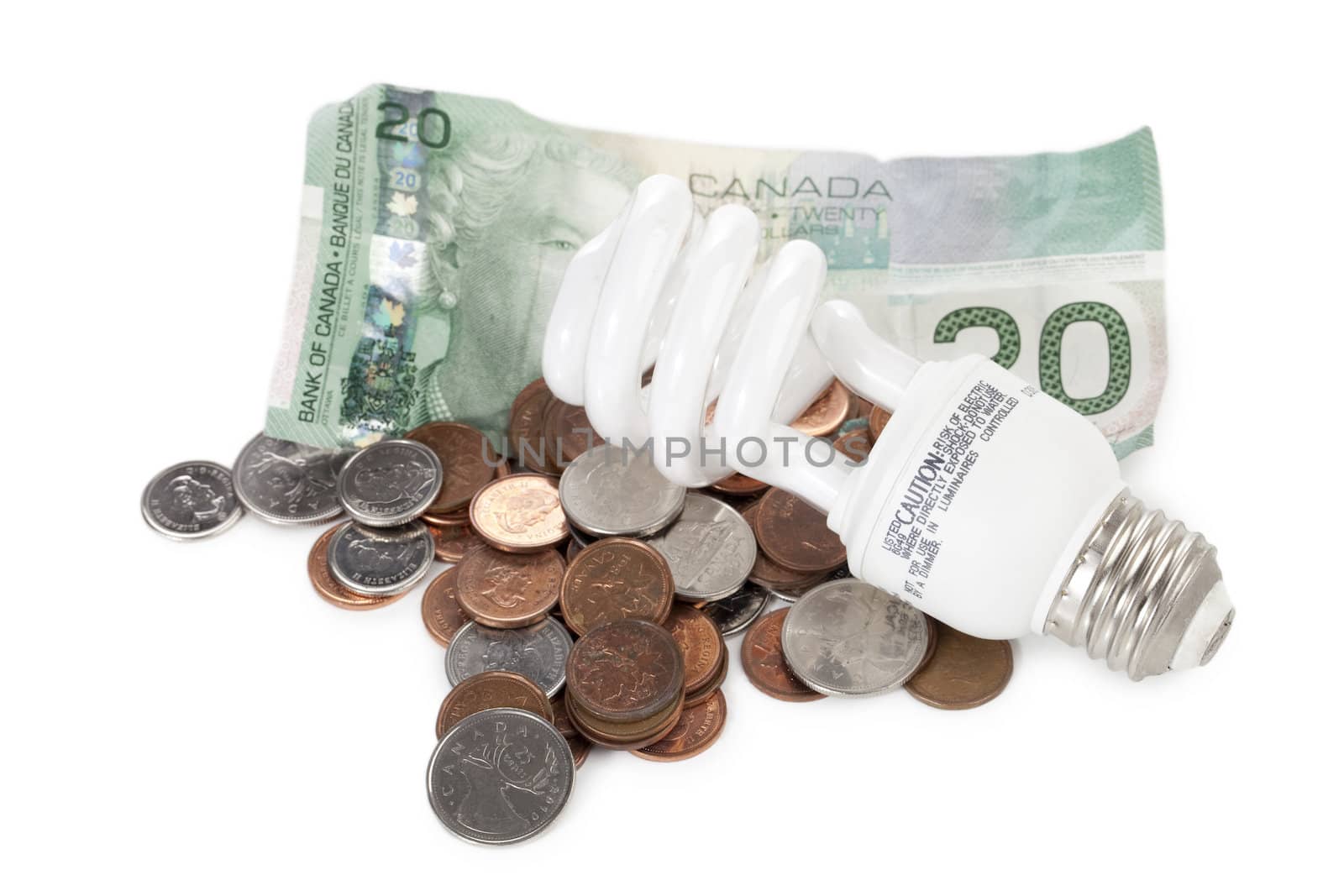 Close up image of light bulb, dollar and coins against white background