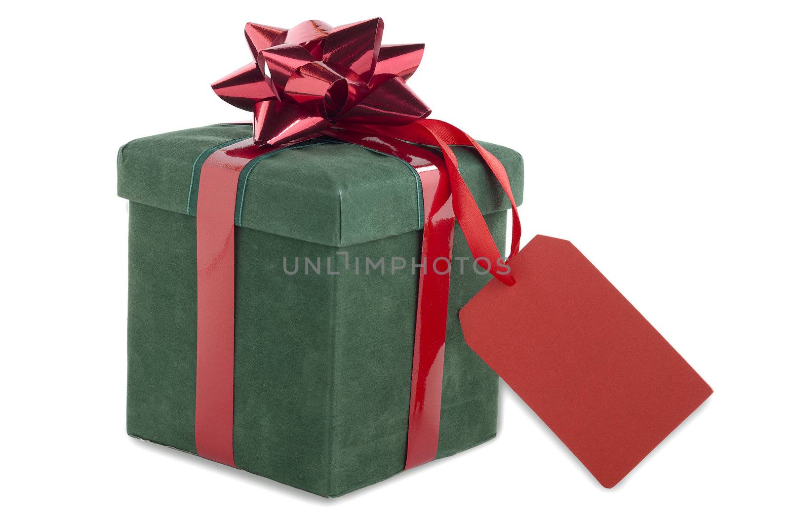 Close-up shot of green gift box tied with bow with red empty placard.