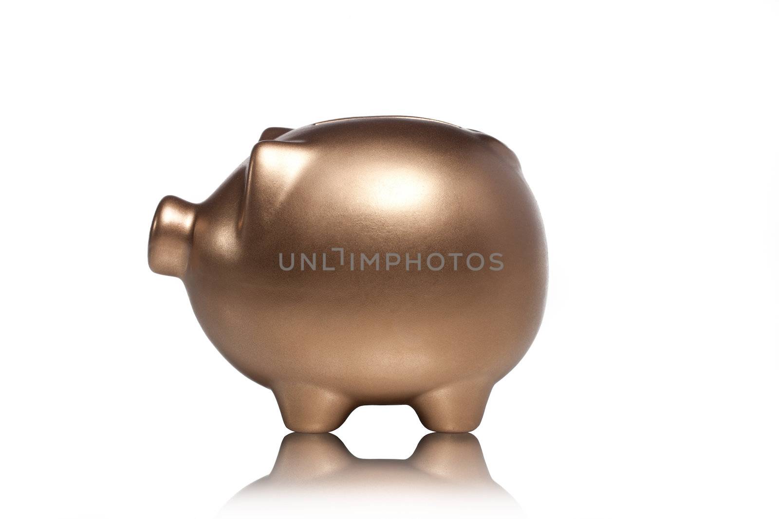 Detailed shot of gold piggy bank on plain white background.