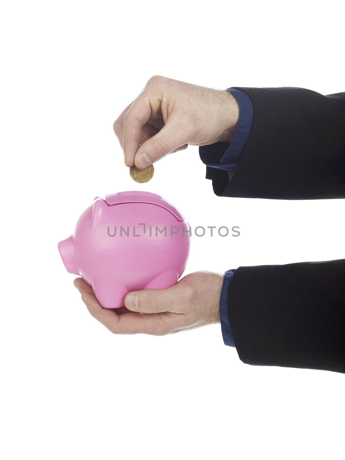 Human hand holding coin over pink piggy bank against white background